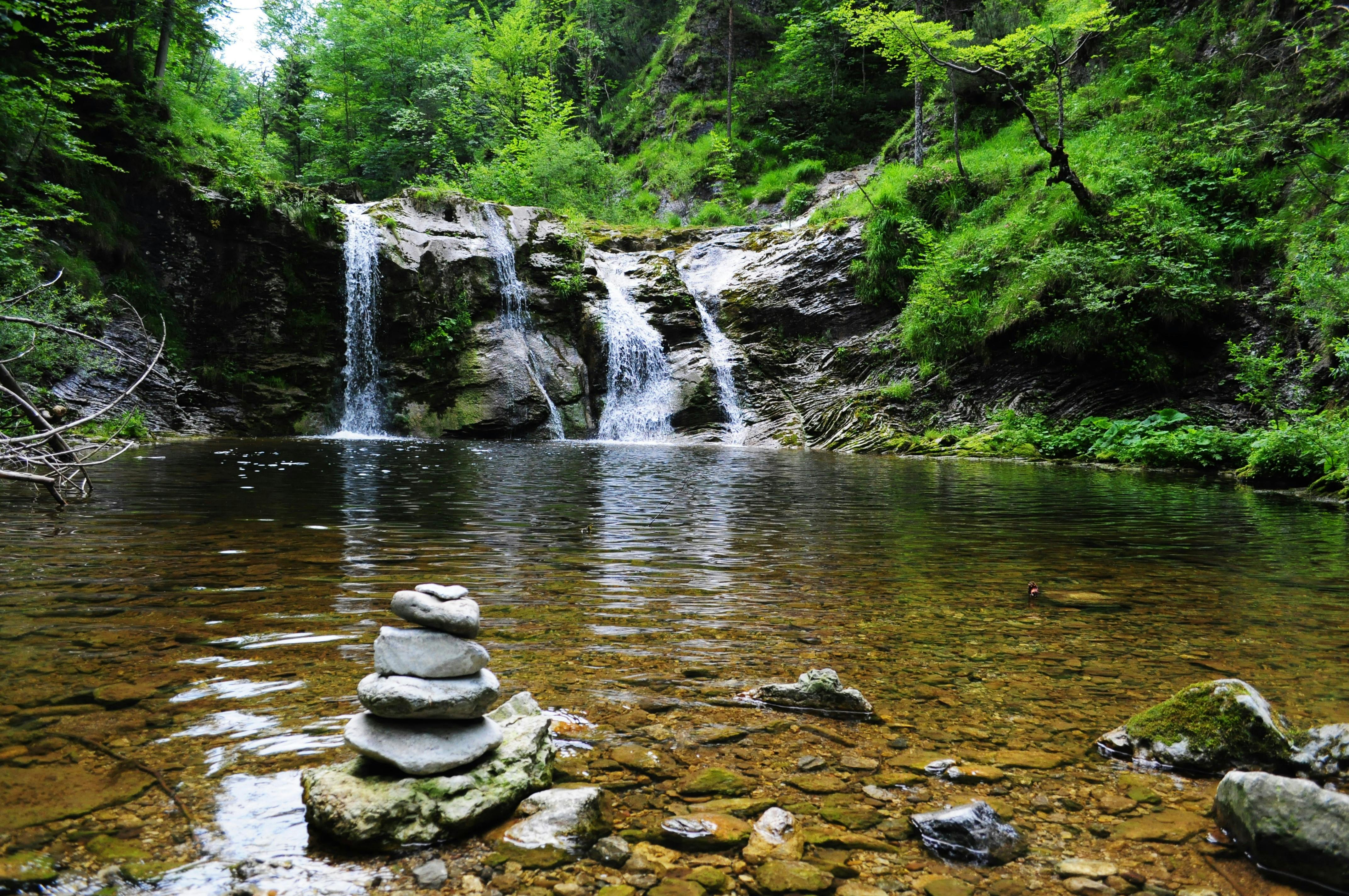 Mountain River Fall with Stacked Rocks
